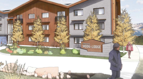 exterior of modu-lodge with landscaping, and man standing in walkway