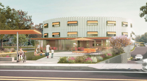 A street view of a curved building with awnings above the windows and patio out front with a woman holding a child's hand walking toward the building and people sitting on the front lawn