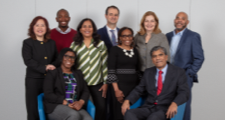 FHLBank Boston female and male employees seated next to each other with four female employees and three male employees standing behind them
