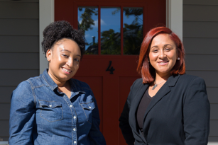 two smiling women standing next to each other