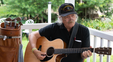 male veteran playing guitar