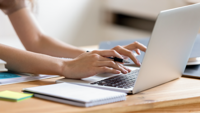 A person typing on a laptop