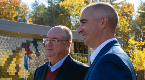 A profile photo of two male leaders of Saco & Biddeford Savings Institution standing outdoor next to each other.
