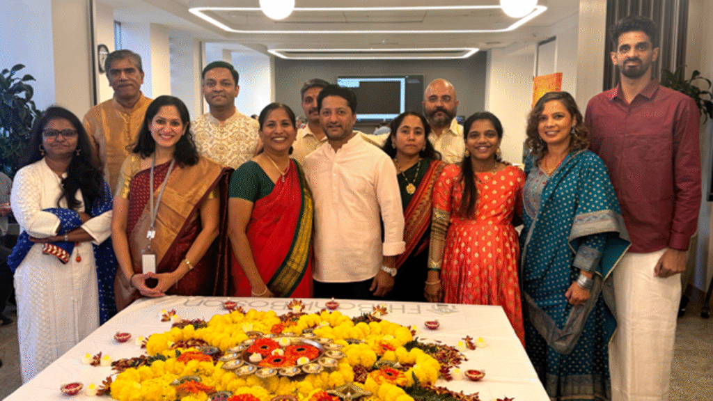 Twelve FHLBank Boston employees wearing traditional Indian attire gather to celebrate Diwali