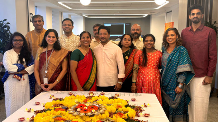 Twelve FHLBank Boston employees wearing traditional Indian attire gather to celebrate Diwali.
