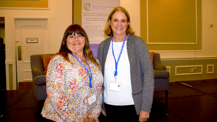 two female FHLBank Boston employees standing next to each other at a women's conference
